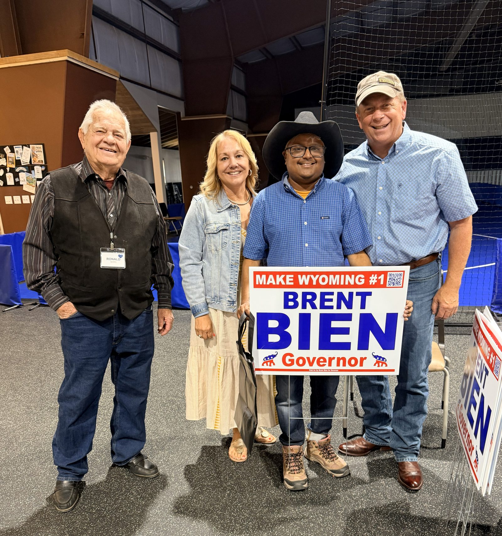 Brent Bien with Wyoming families holding a campaign yard sign
